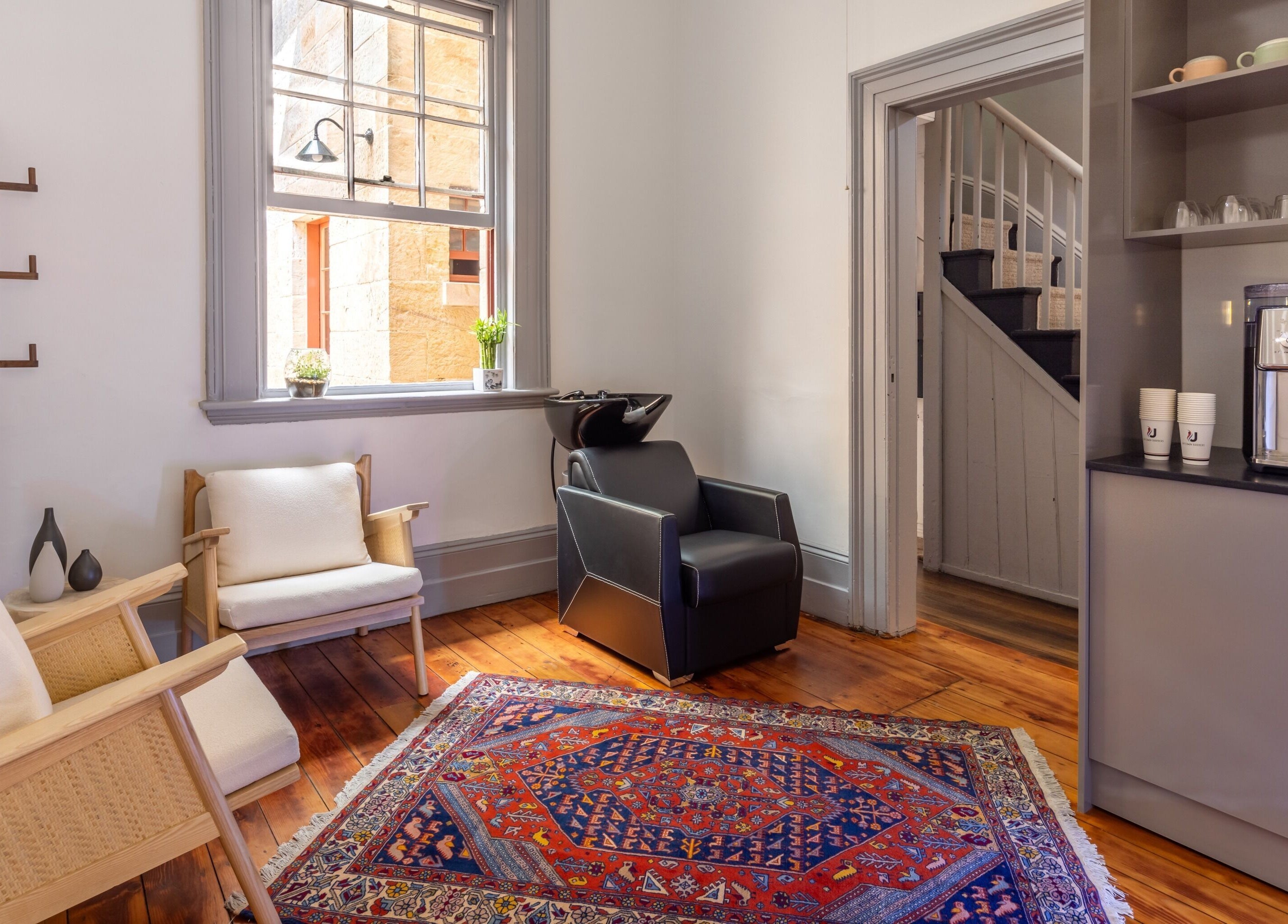 Relaxing seating area in Uptown Barbers The Rocks, The Rocks, New South Wales, AU with stylish decor.
