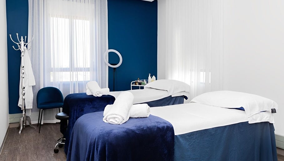 Massage room at Bespoke Word Counseling, Centurion, Gauteng, ZA, featuring two treatment beds with blue covers.