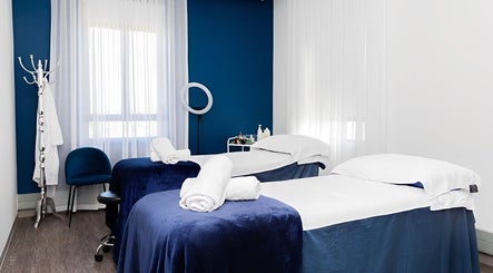 Massage room at Bespoke Word Counseling, Centurion, Gauteng, ZA, featuring two treatment beds with blue covers.