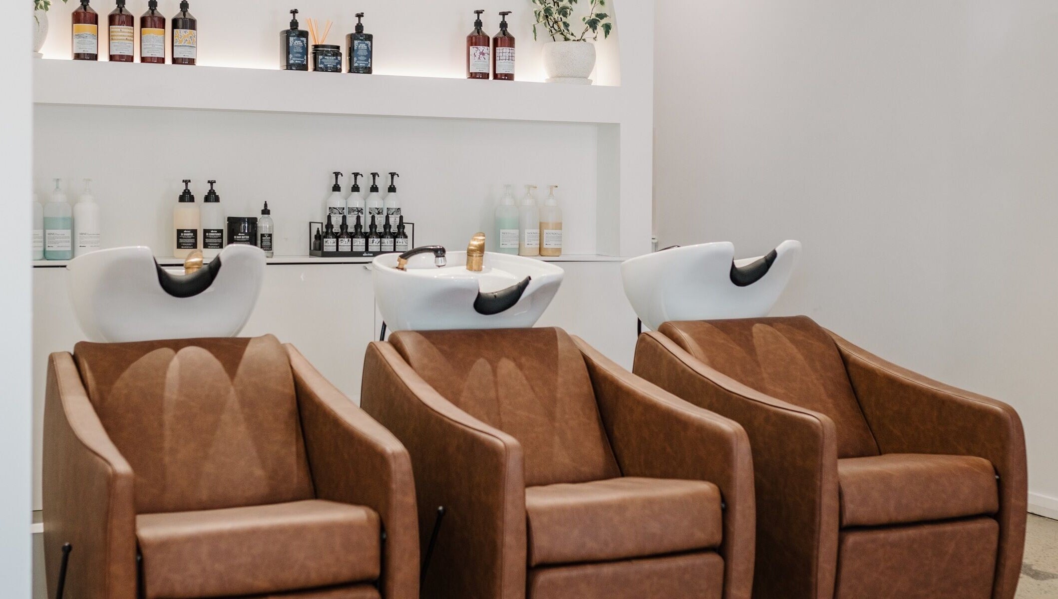 Elegant salon chairs and wash stations at Mooi Studio, Glenelg, South Australia, AU.