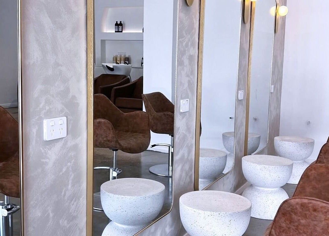 Stylish salon chairs at Mooi Studio, Glenelg, South Australia, AU featuring elegant mirrors and modern decor.