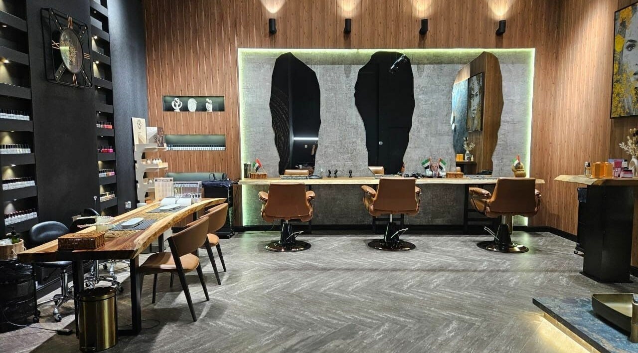 Modern interior of Arez Beauty Center in Dubai, AE featuring chic chairs and sleek mirrors.