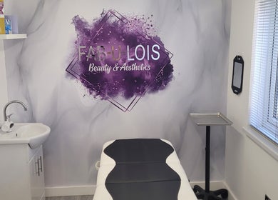Massage room at FAB-U-LOIS Beauty and Aesthetics, Rustington, England, with treatment bed and artful decor.