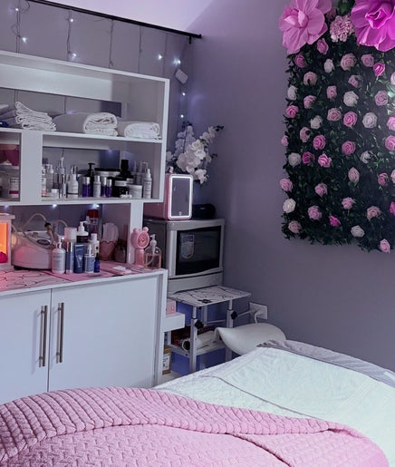 Calm treatment room at Skin Serenity Spa and Wax Studio, Tunapuna, TT with pink decor and floral accents.