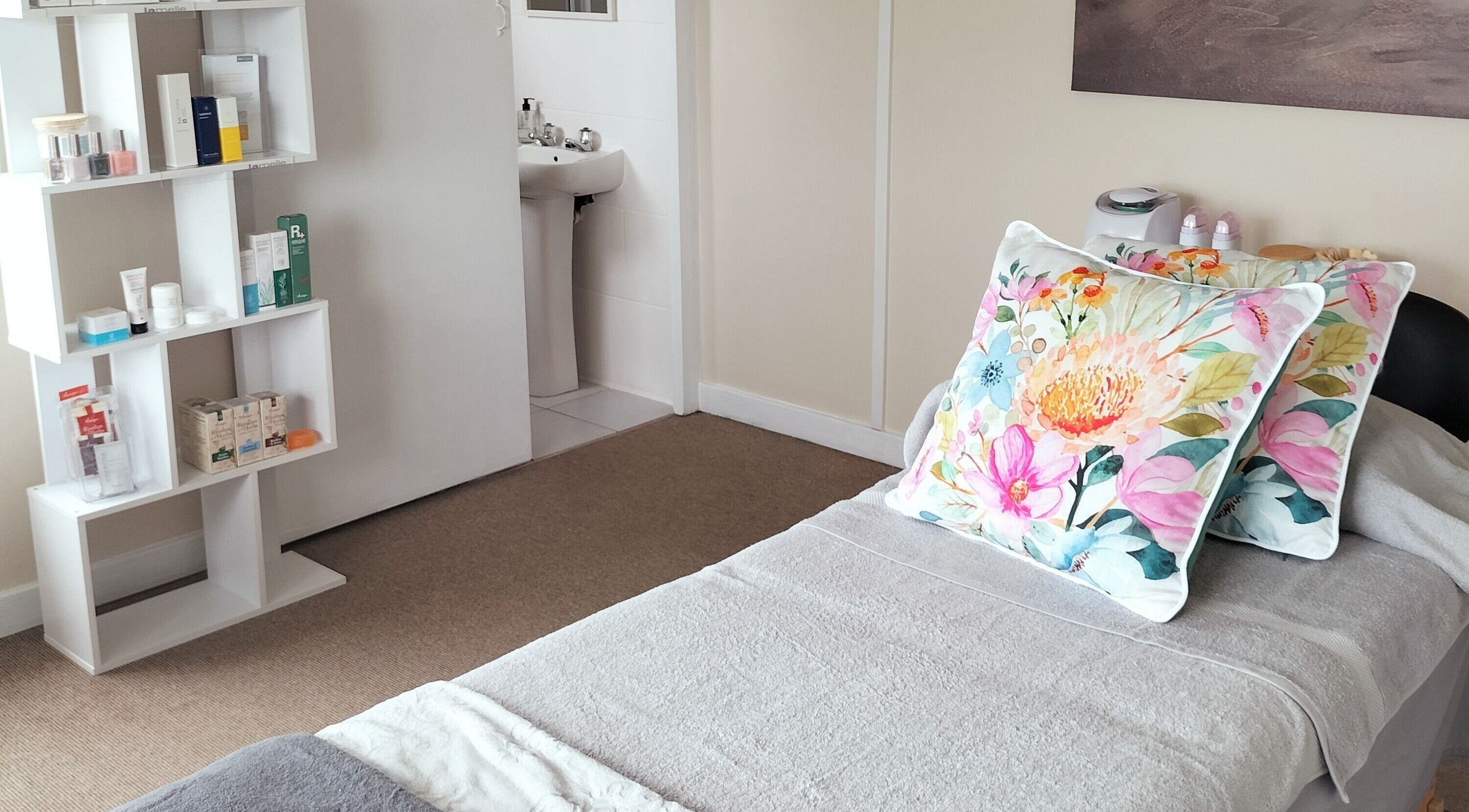 Calming treatment room at Bloom Beauty, Cape St Francis Bay, Eastern Cape, ZA, with floral decor and product display.