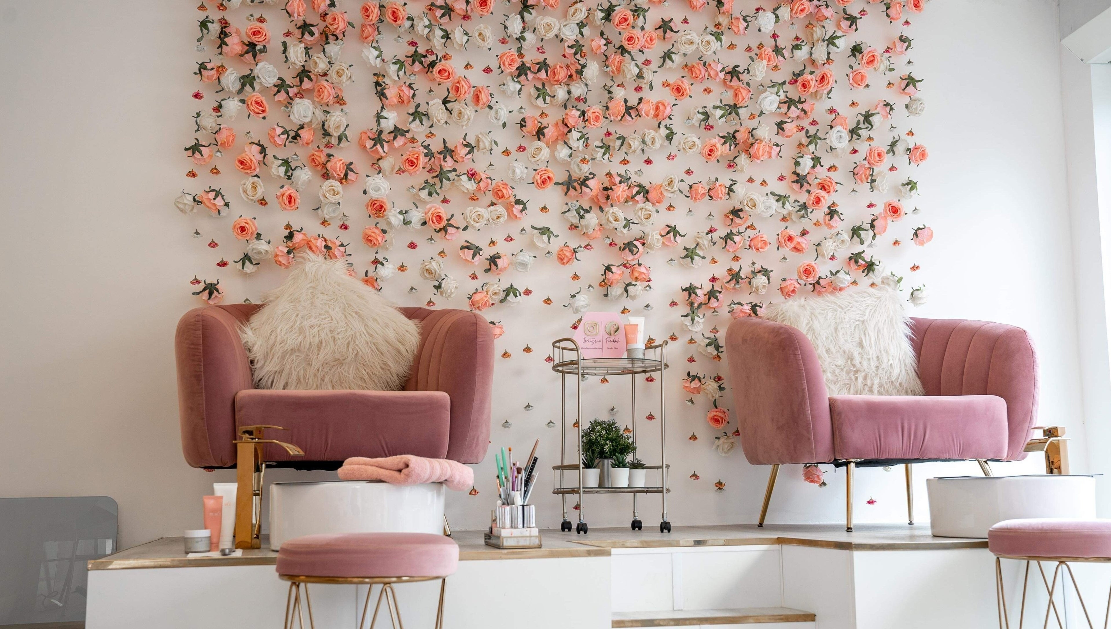 Chic salon chairs with floral wall at Studio One Nails and Beauty in New Milton, England, GB.