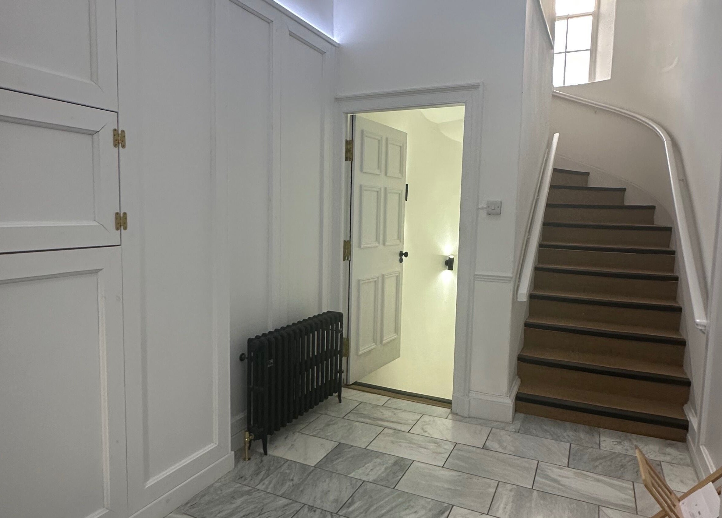 Chic staircase and white decor at Lashes by Katie, Ayr, Scotland, GB welcoming guests.