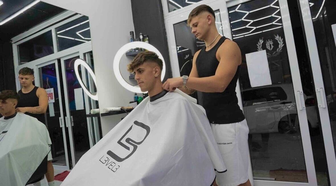 Stylist expertly cuts a client's hair at Izzy’s Hair Studio in Sliema, MT stylish and modern setting.