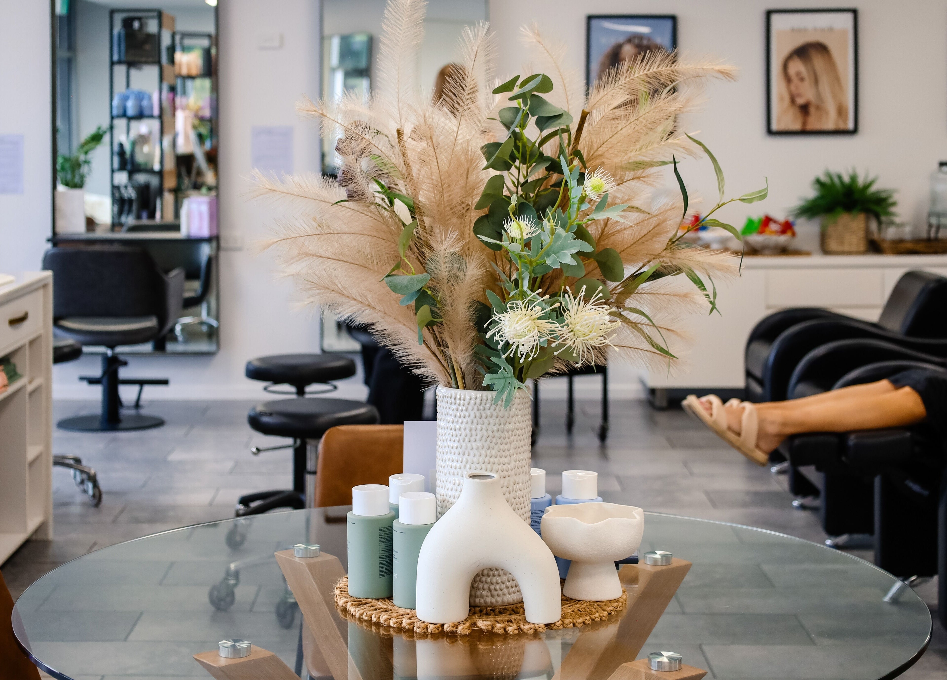 Inviting interior of Fusion Hair in Woree, Queensland, AU with stylish decor and salon stations.