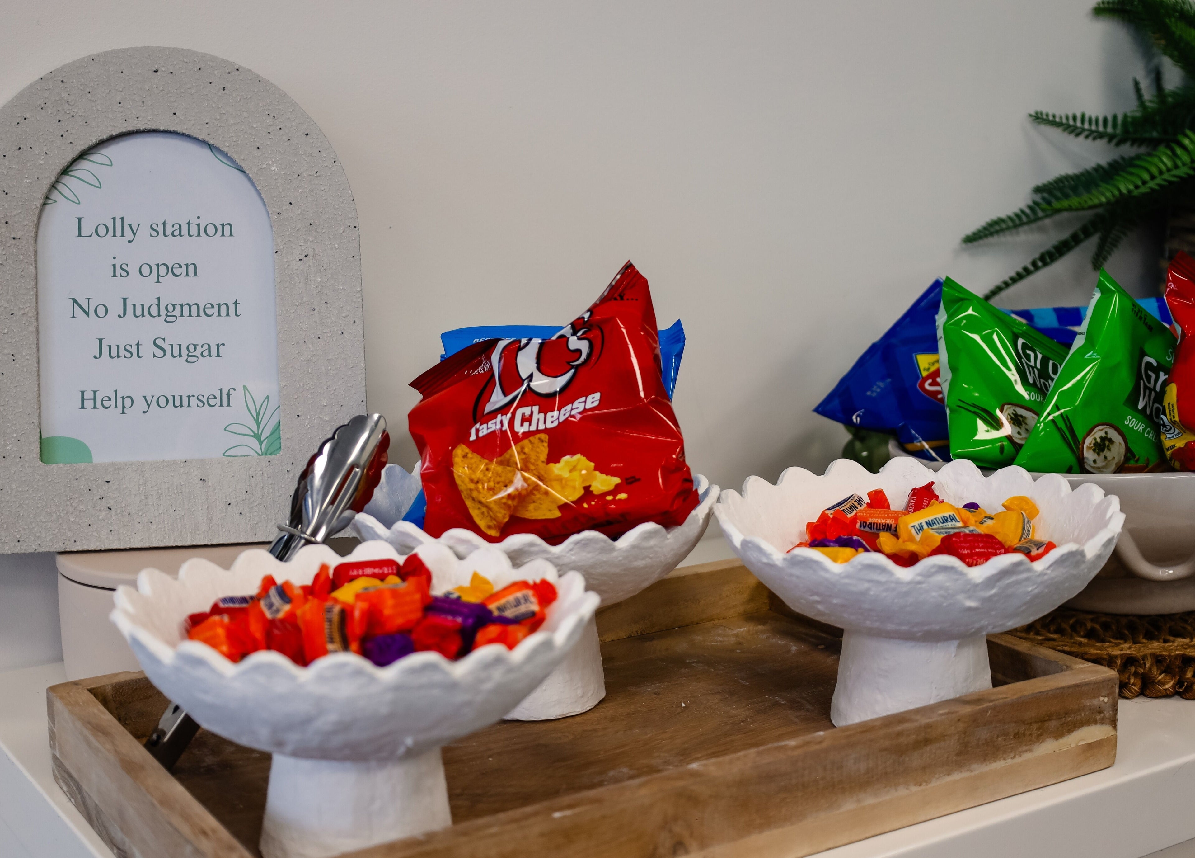 Lolly station at Fusion Hair in Woree, Queensland, AU, featuring snacks and sweets in decorative bowls.