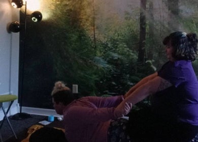 A serene massage session at Valpo Mamabear Massage & Float, Valparaiso, Indiana, US, with a forest backdrop.