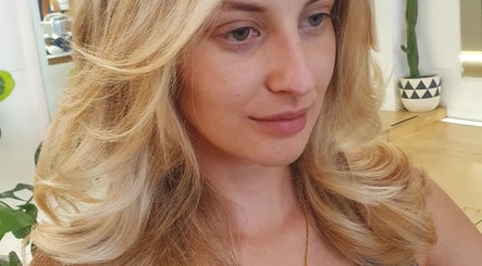 Blonde woman with styled curls at Massi Aldini in Paddington, New South Wales, AU.