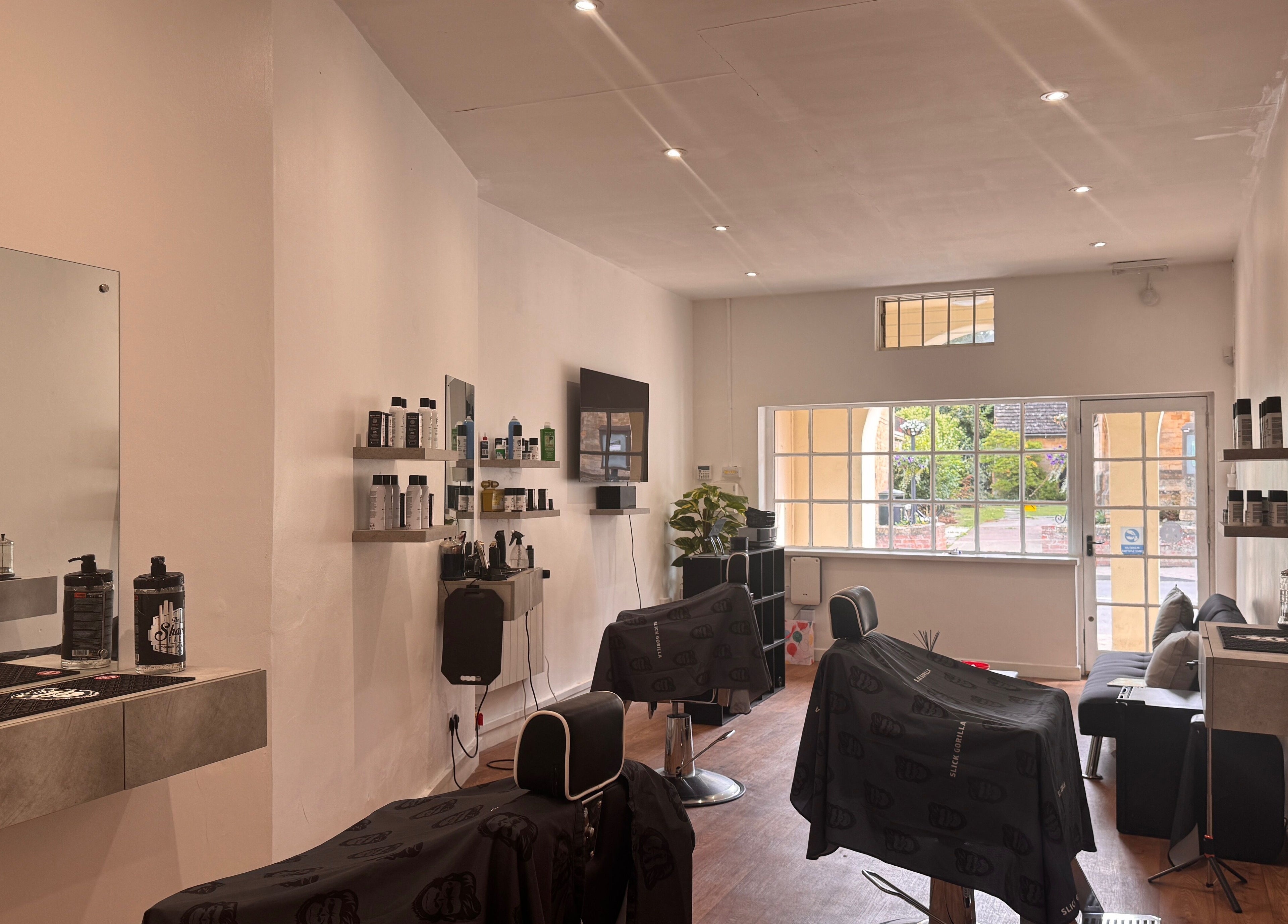 Modern salon interior at Studio7 in Shipston-on-stour, England, GB, featuring sleek chairs and large windows.