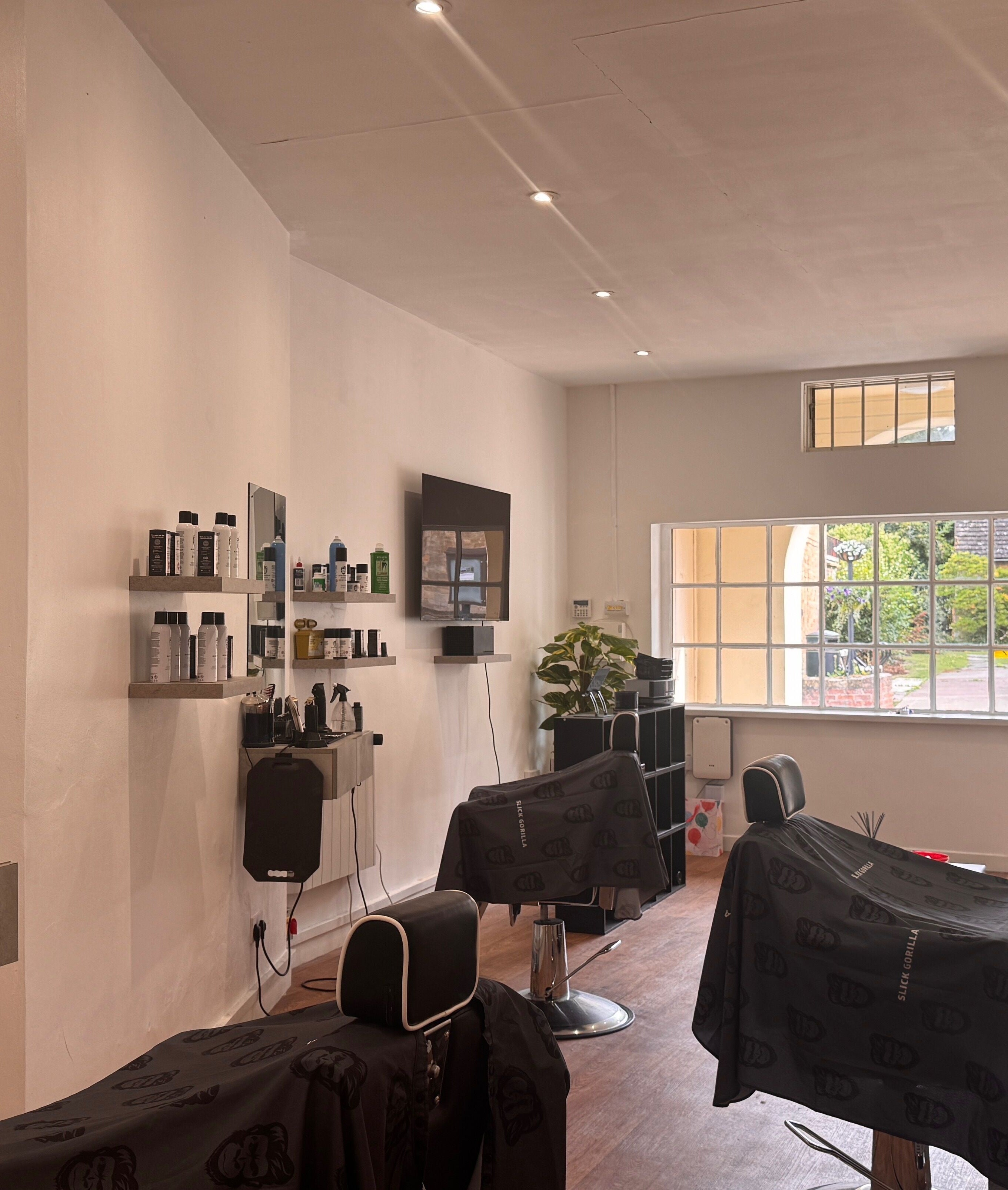 Modern salon interior at Studio7 in Shipston-on-stour, England, GB, featuring sleek chairs and large windows.