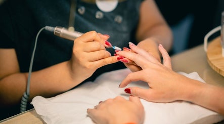 Professional manicure session at Alvalade - Glowing Beauty, Lisboa, Lisboa, PT with vibrant red polish.