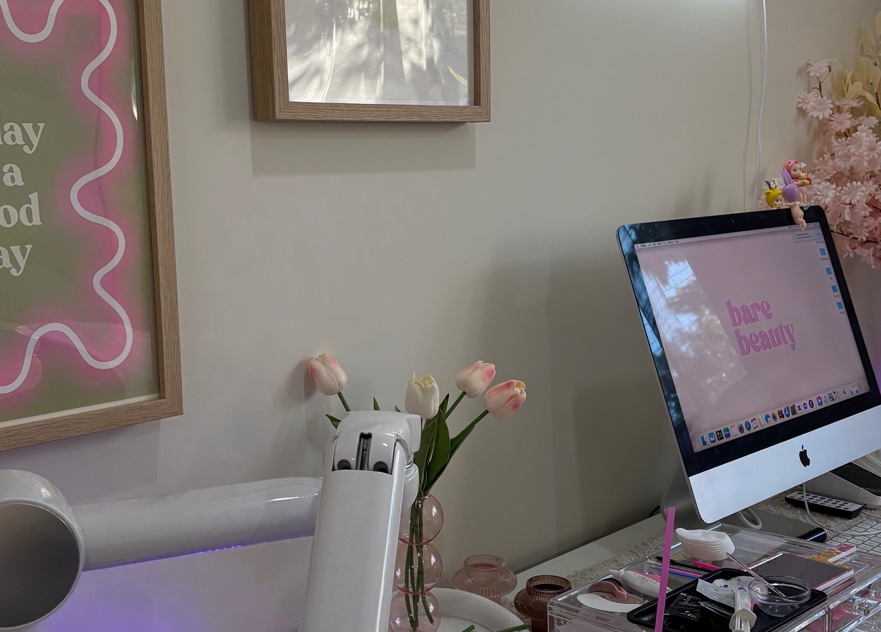 Elegant workspace at Barebeauty, Mudgeeraba, Queensland, AU with pastel decor and vibrant flowers.
