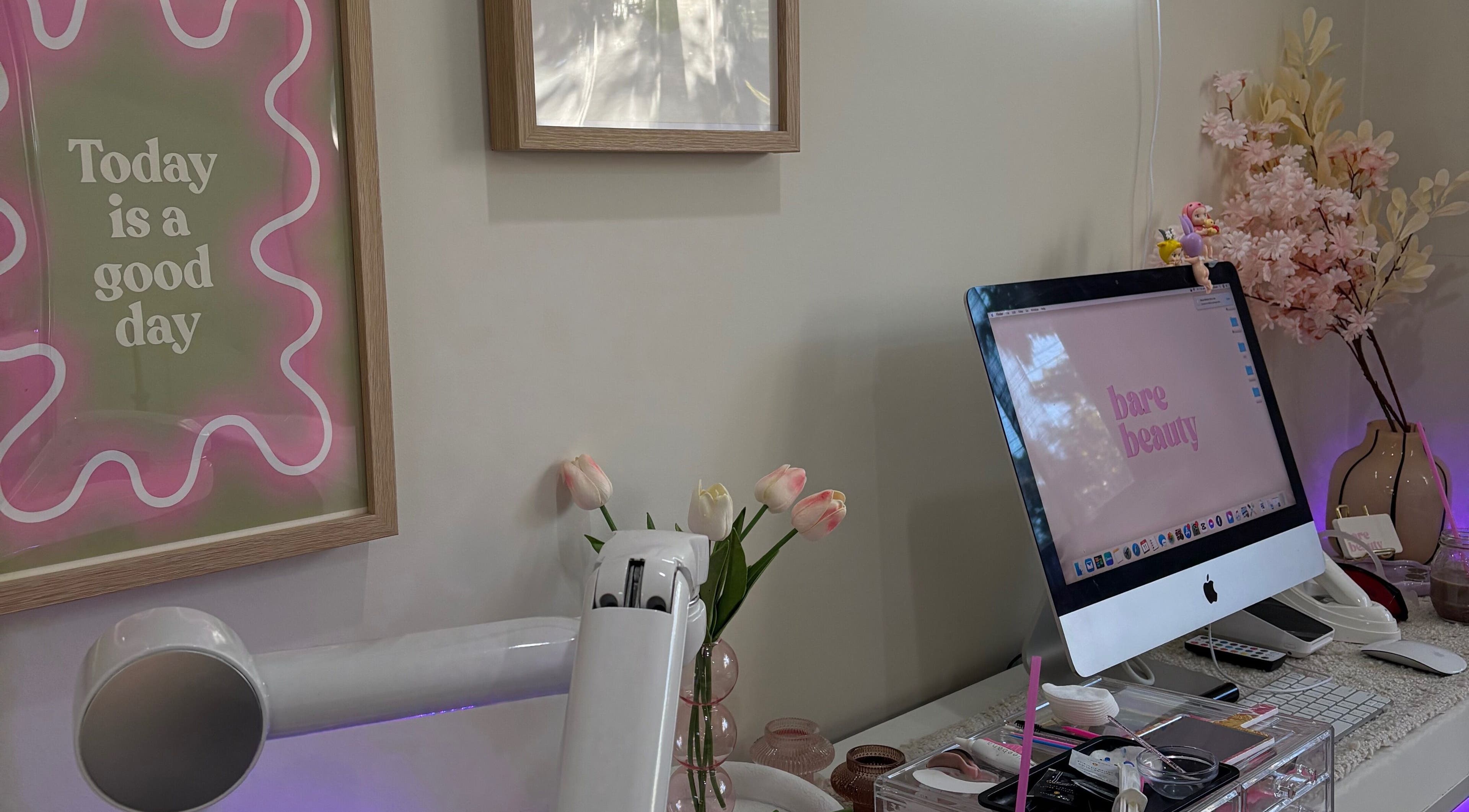Elegant workspace at Barebeauty, Mudgeeraba, Queensland, AU with pastel decor and vibrant flowers.