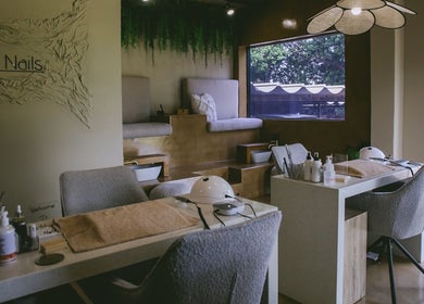Elegant interior of Kri8tive Nails, Pretoria, Gauteng, ZA, featuring plush seating and nail care stations.