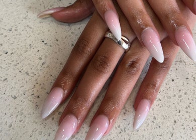Elegant pink and white ombre nails from Kri8tive Nails, Pretoria, Gauteng, ZA on textured surface.