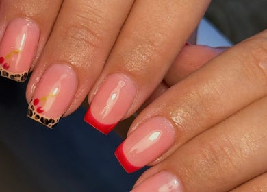 Stylish nail art at Holly’s Beauty, Bridgwater, England, GB, featuring red and leopard print accents.