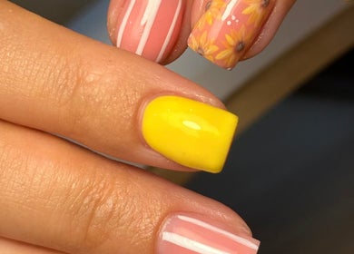 Vibrant nail art with floral and striped design at Holly’s Beauty, Bridgwater, England, GB.