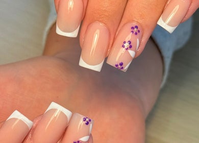 Elegant French manicure with floral design at Holly’s Beauty, Bridgwater, England, GB. Perfect for a chic look.