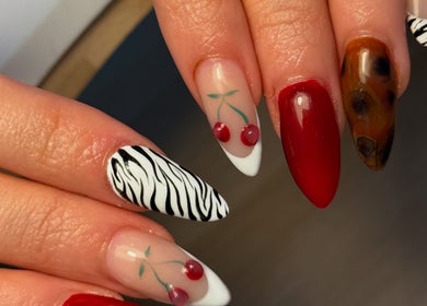 Stylish nail designs at Holly’s Beauty, Bridgwater, England, GB with cherries, zebra, and rich hues.