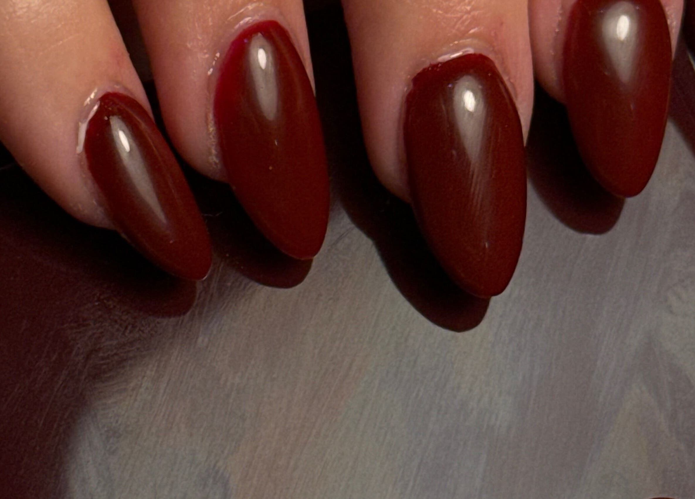 Claret-colored manicured nails at Holly’s Beauty, Bridgwater, England, GB, showcasing expert nail artistry.