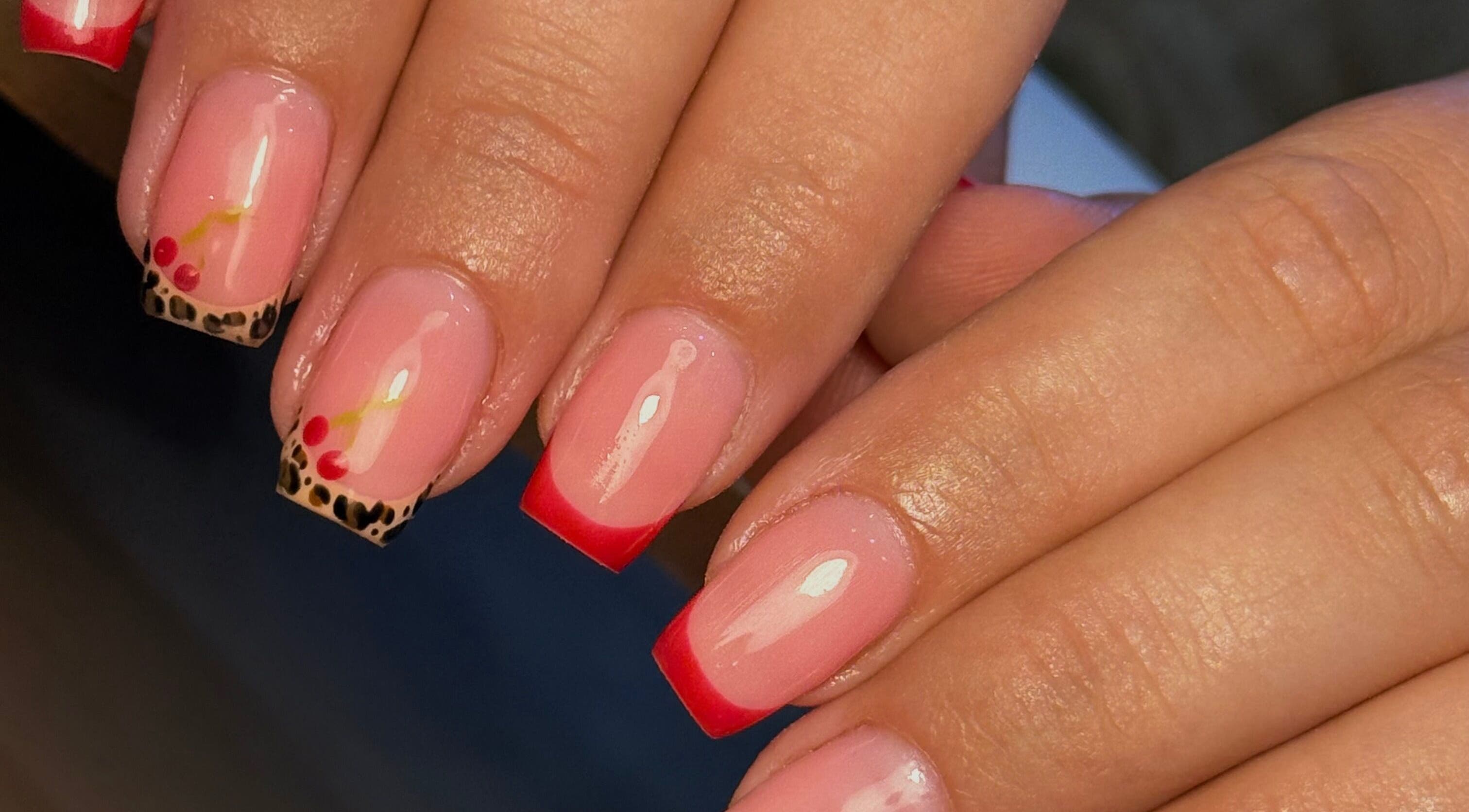 Stylish red and leopard nail art at Holly’s Beauty, Bridgwater, England, GB.