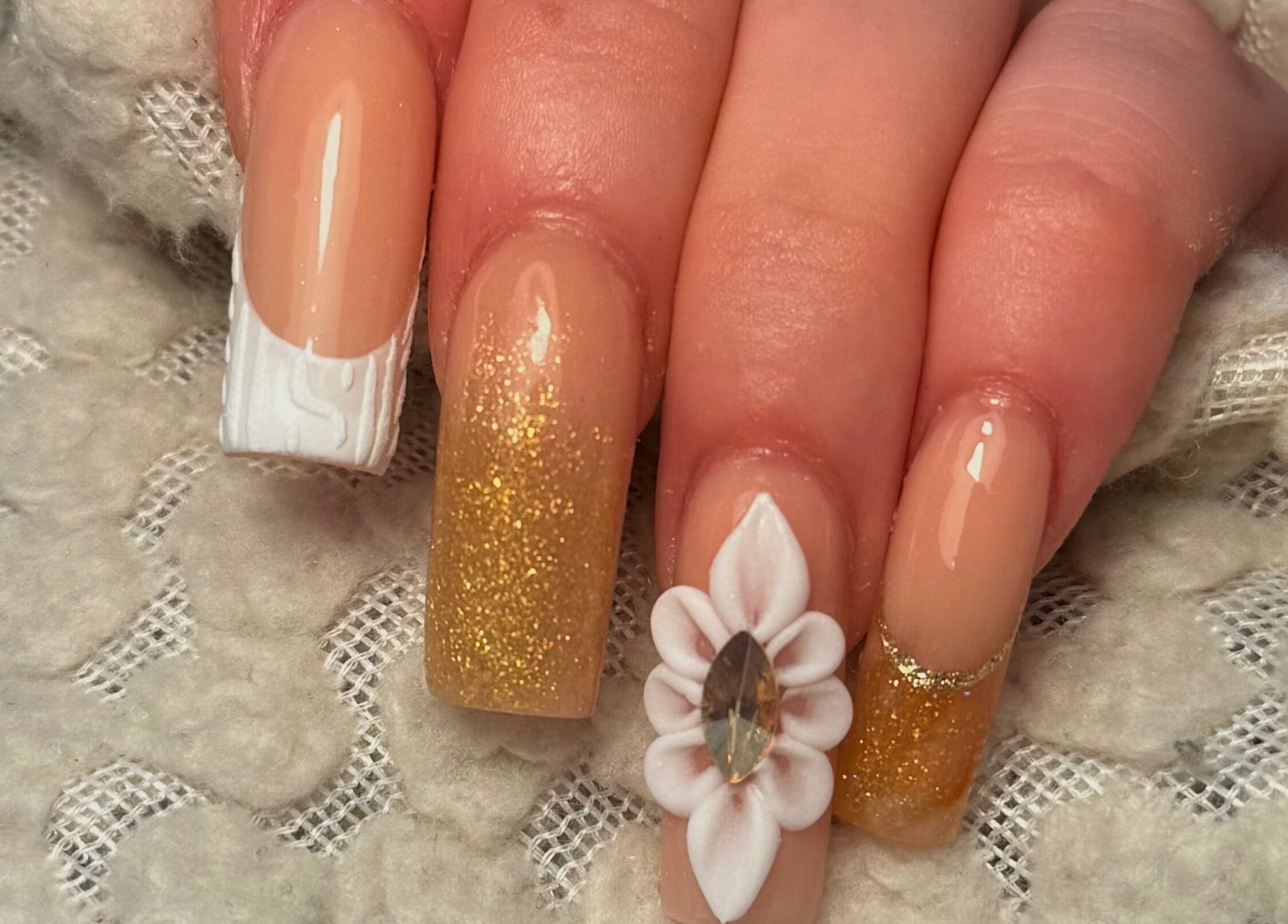 Elegant nail art with gold glitter at Holly’s Beauty, Bridgwater, England, GB.