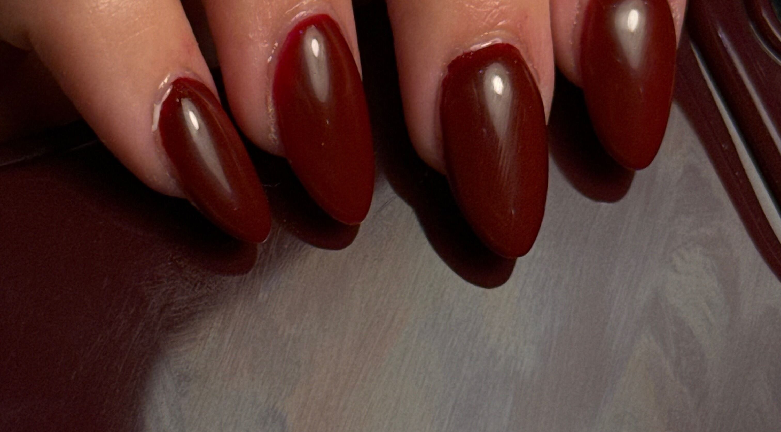 Elegant burgundy nails manicured at Holly’s Beauty in Bridgwater, England, GB. Perfect for a sophisticated look.