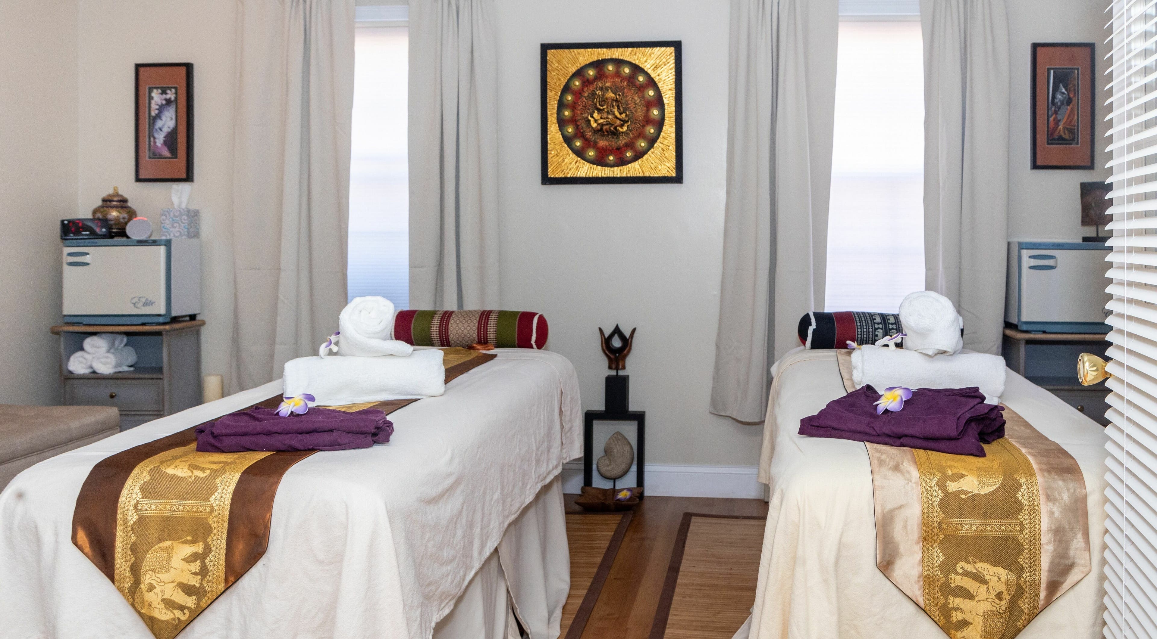 Tranquil massage room at Amazing Thai Massage, Crofton, Maryland, US, featuring two decorated tables.