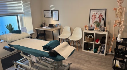Tay Sports Therapy treatment room in Perth, Scotland, GB, featuring a massage table and anatomical models.