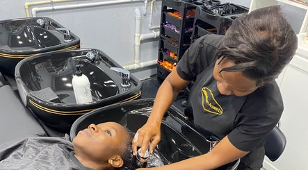 A stylist washes a client's hair at Hava's Beauty Bar, Port of Spain, enhancing relaxation and care.