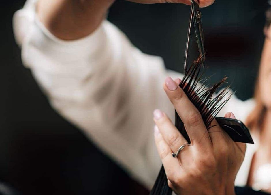 Expert stylist at Headcases Hair Salon in Ashbourne, IE skillfully cutting hair with precision scissors.