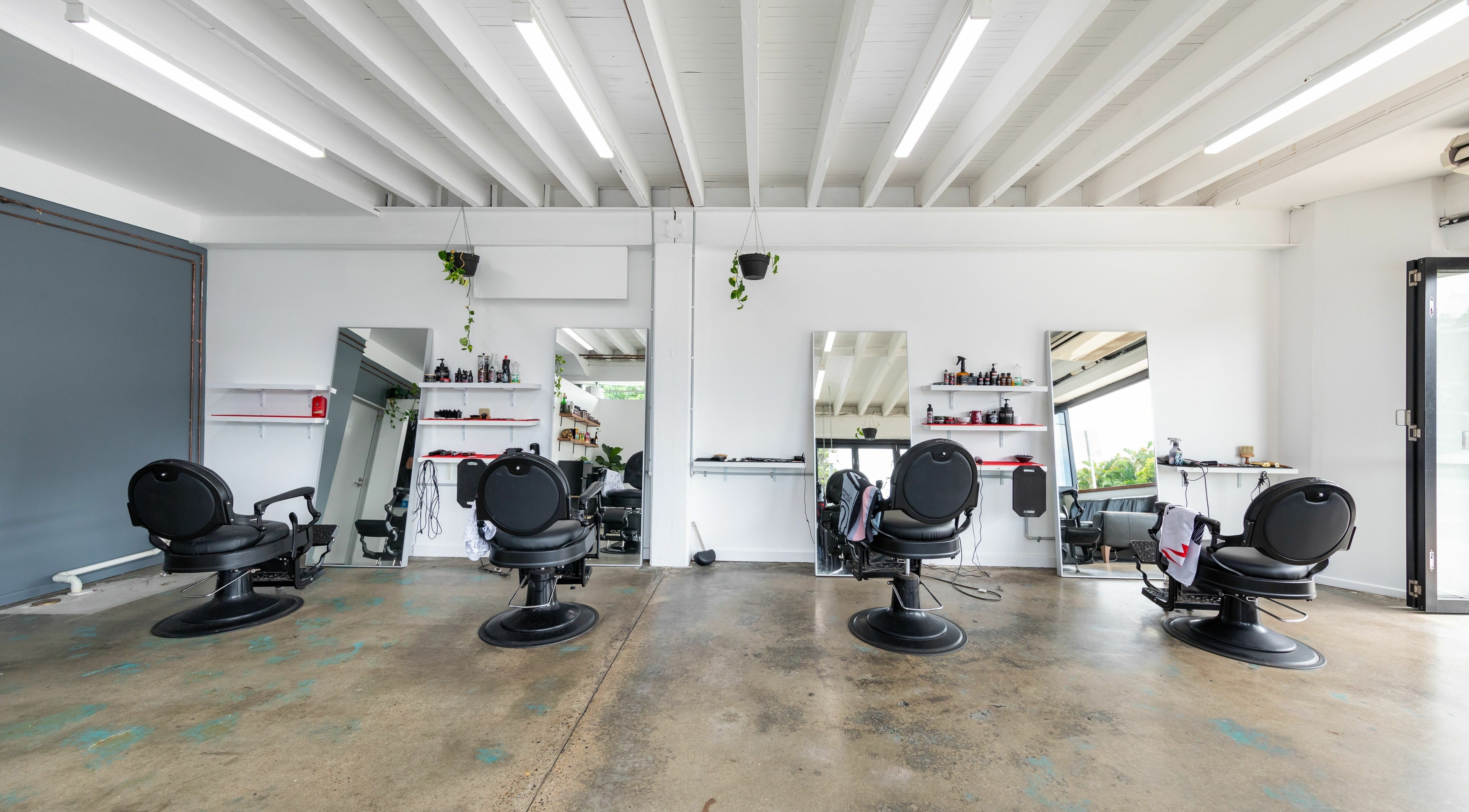 Modern interior of Boy Barbershop - Mermaid Beach, featuring sleek barber chairs in Mermaid Beach, QLD, AU.