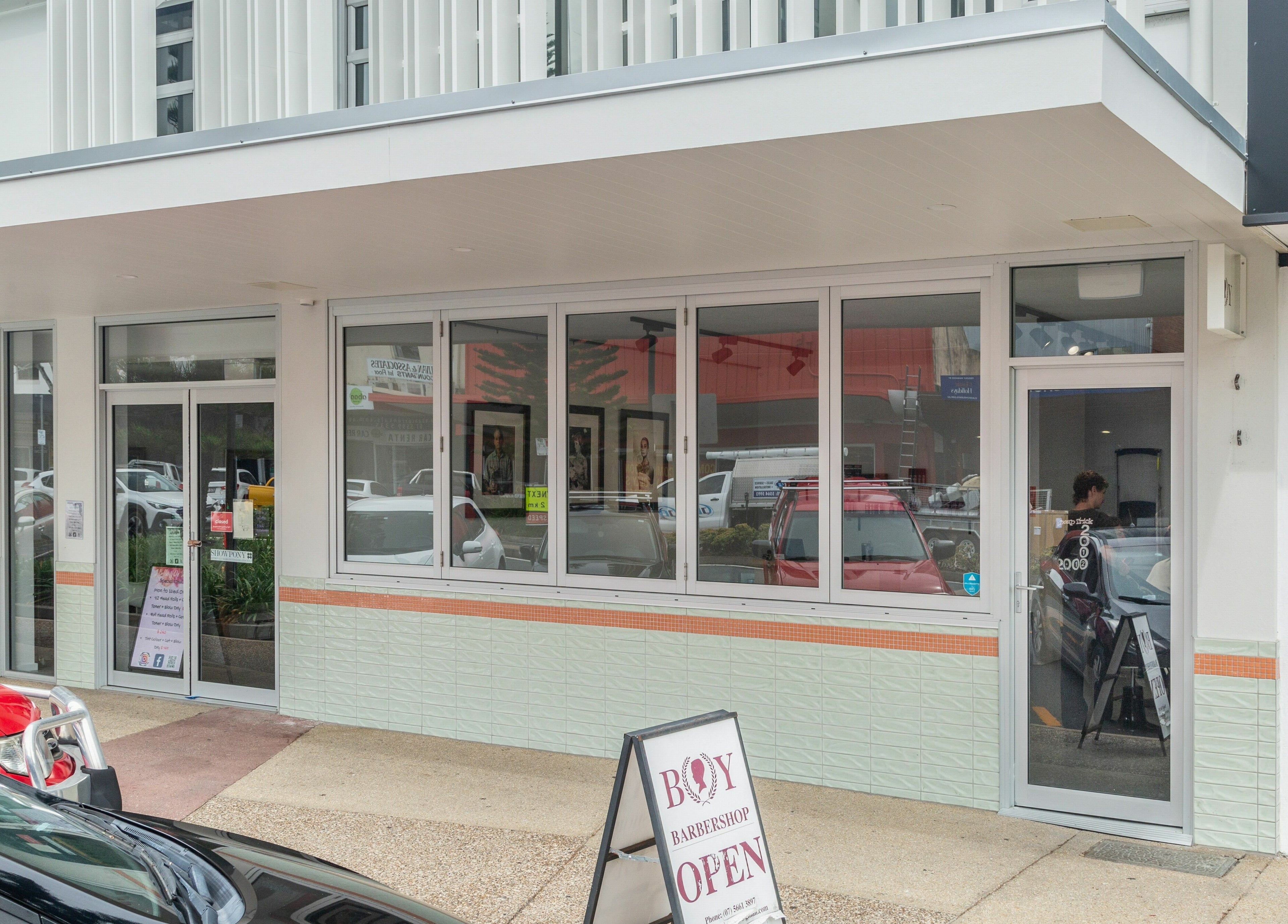 Street view of Boy Barbershop in Coolangatta, QLD, AU with a modern exterior design.