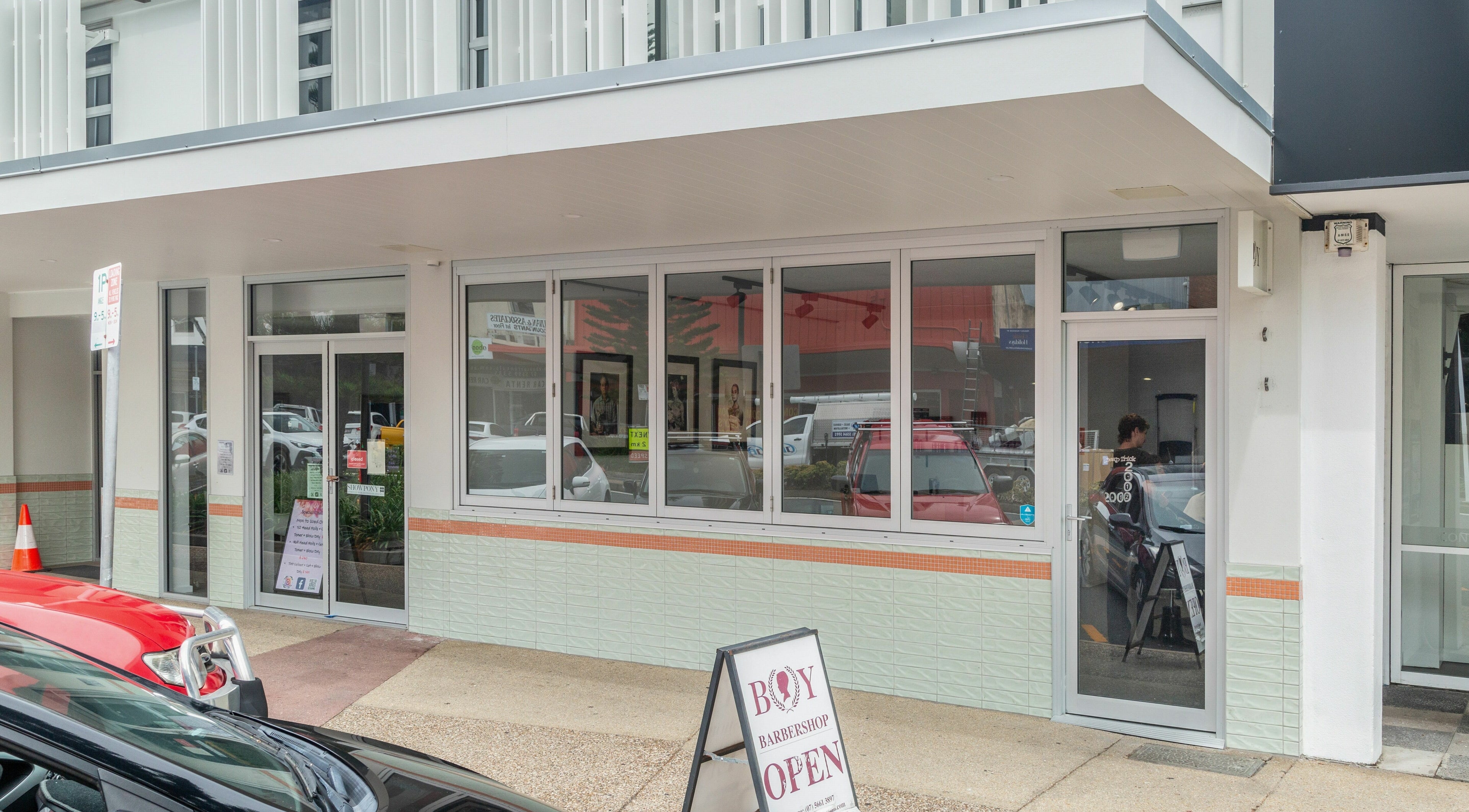 Street view of Boy Barbershop in Coolangatta, QLD, AU with a modern exterior design.