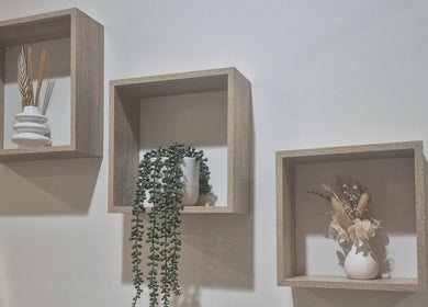 Elegant wall decor at Radiant Skin & Body By Jo, Pie Creek, Queensland, AU, featuring shelves with plants and vases.