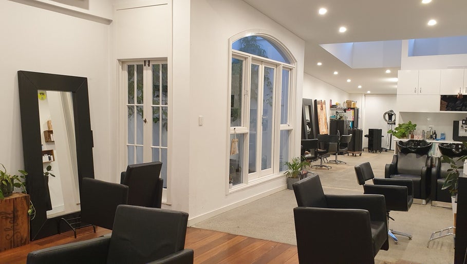 Bright, elegant interior of Flourish Eco Hair in Subiaco, Western Australia, AU with modern styling chairs.