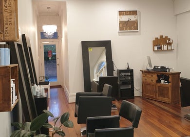 Chic interior of Flourish Eco Hair in Subiaco, Western Australia, AU with stylish chairs and mirrors.