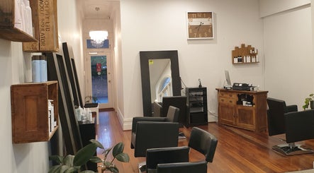 Chic interior of Flourish Eco Hair in Subiaco, Western Australia, AU with stylish chairs and mirrors.