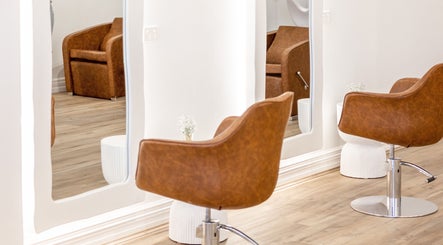 Flourish Eco Hair salon in Mount Lawley, Western Australia featuring elegant wooden styling chairs.