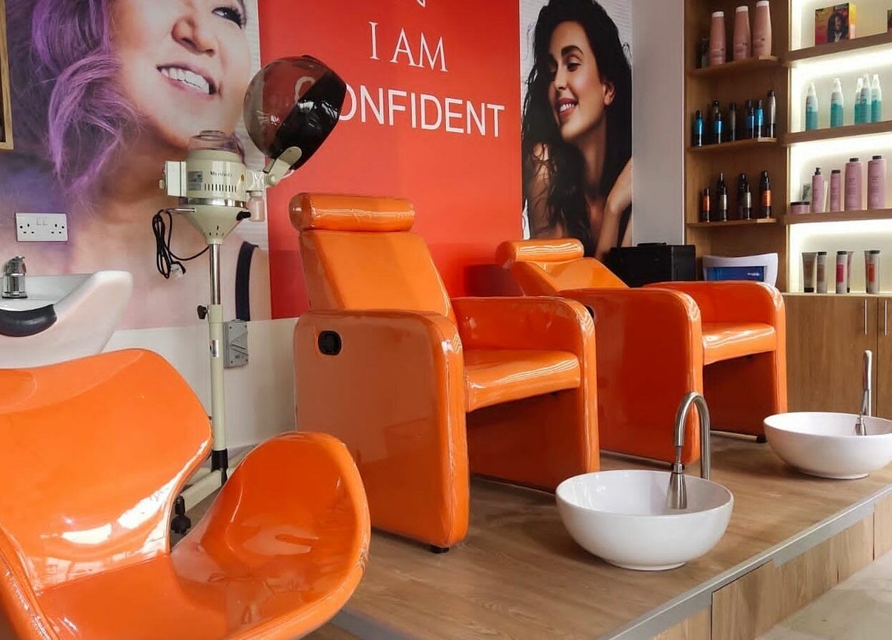 Bright orange chairs and beauty setup at Maya Beauty Salon, Dubai, Dubai, AE, showcasing elegance and comfort.