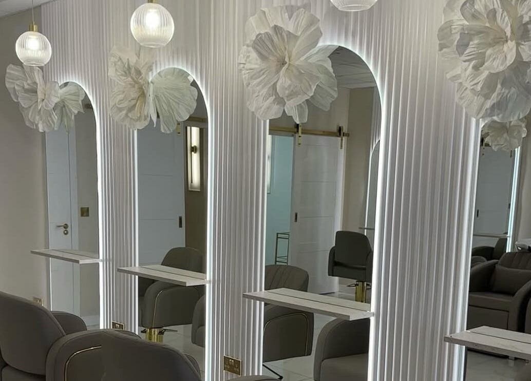 Chic interior of Iona McLauchlan Hairdressing in Stirling, Scotland, GB with modern seating and ambient lighting.