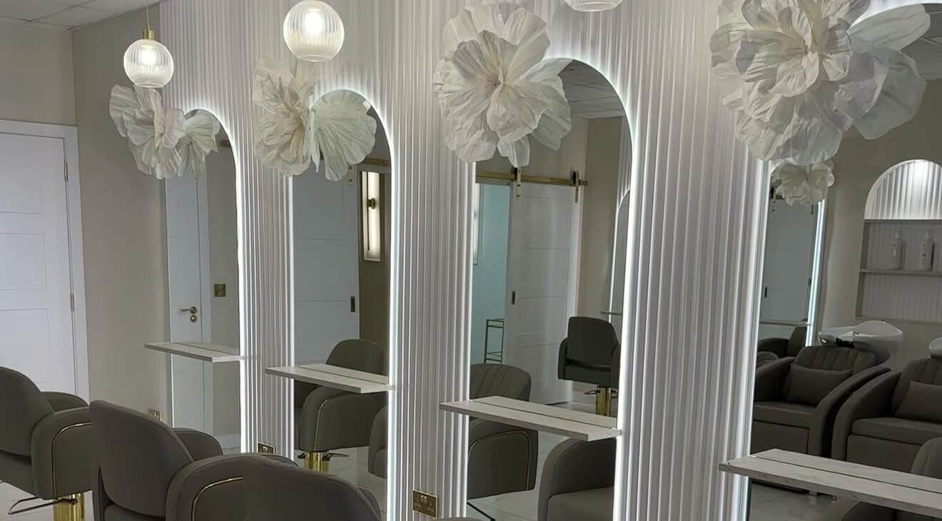 Chic interior of Iona McLauchlan Hairdressing in Stirling, Scotland, GB with modern seating and ambient lighting.