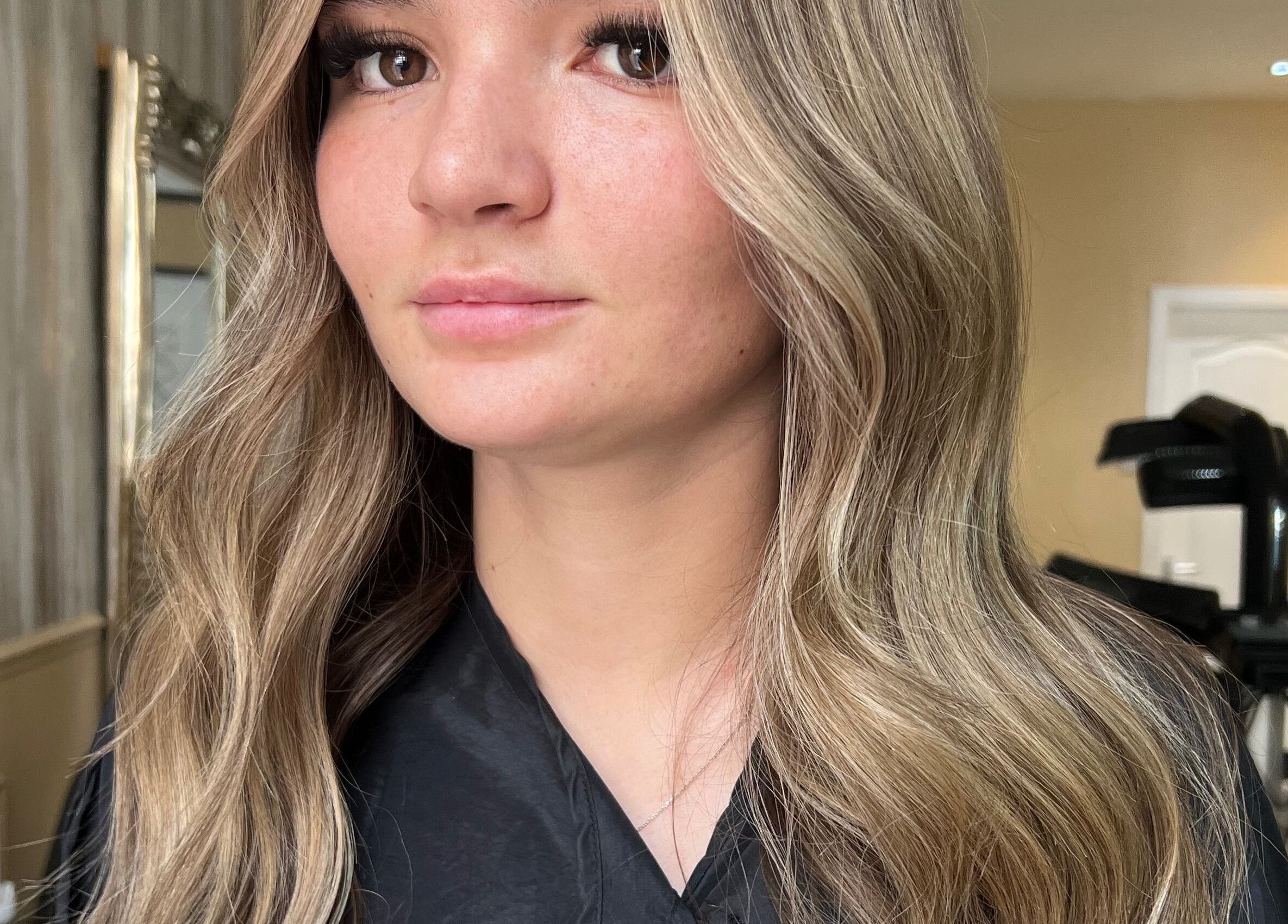 Elegant hair styling at Iona McLauchlan Hairdressing, Stirling, Scotland, GB, showcasing glossy waves.