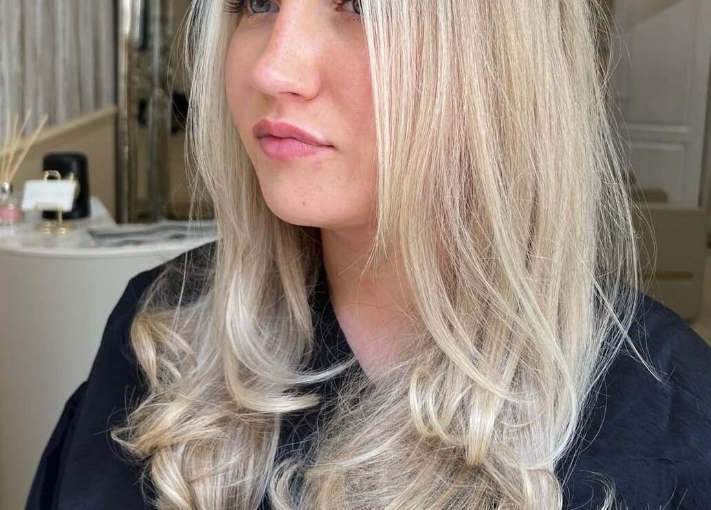 Blonde hairstyle at Iona McLauchlan Hairdressing, Stirling, Scotland, GB. Elegant curls and professional finish.