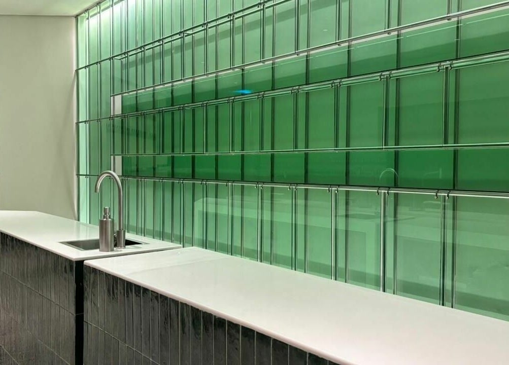 Modern green glass wall and sleek counter at Tend Salon | تند صالون, Riyadh, Riyadh Province, SA.