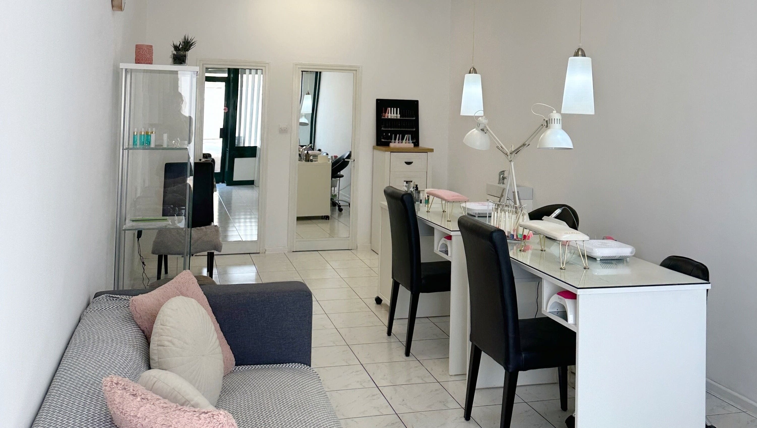 Cozy nail station at Shaped & Polished, Mosta, MT, with modern decor and comfortable seating.